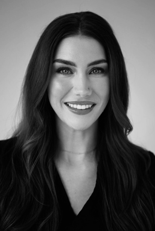 Julianna Pratt is a Licensed Aesthetician at Knoxville Dermatology and Plastic Surgery Woman posing with her hands on her face excentuating her dermal fillers and injections.